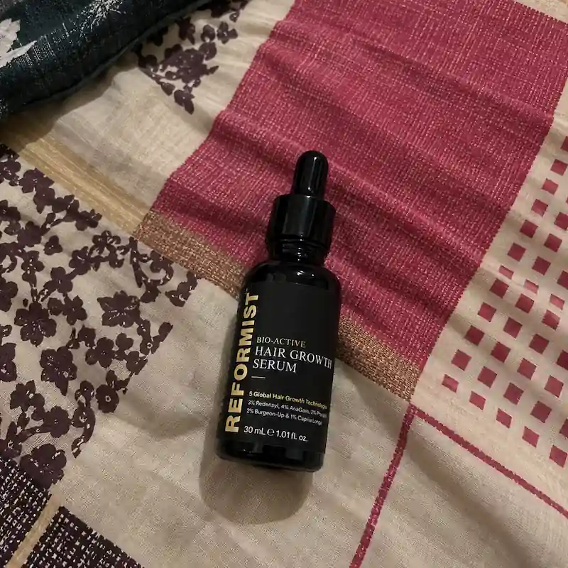 Serum bottle on bedspread
